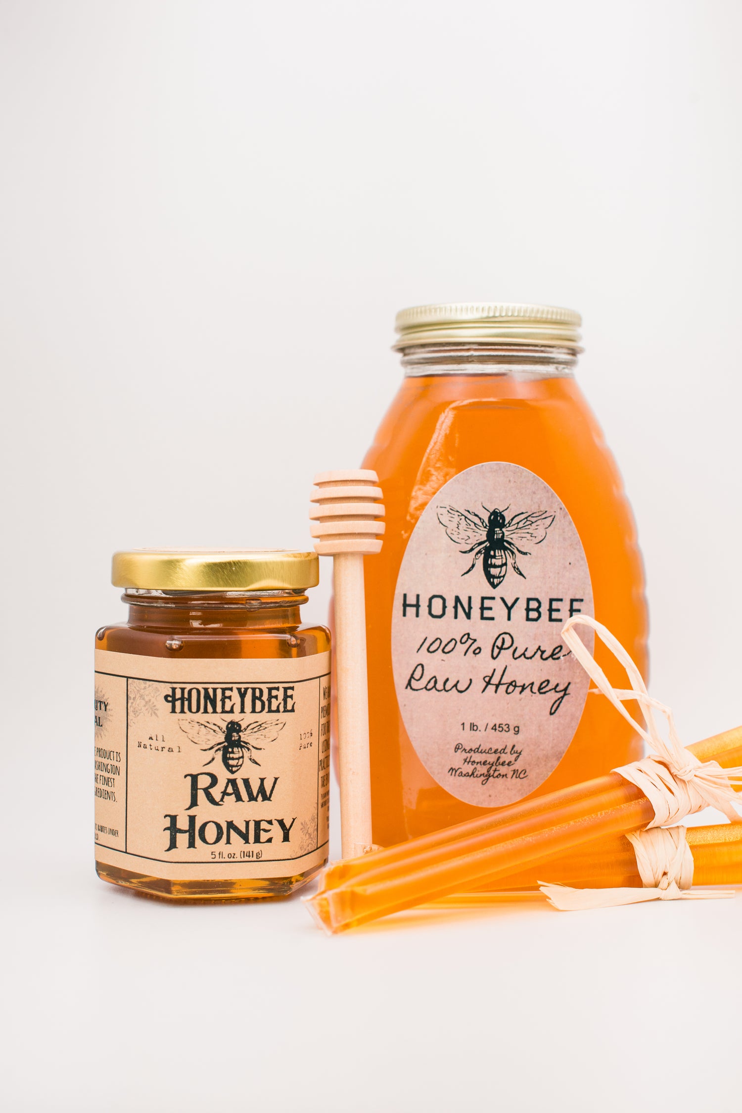 A jar of Honeybee Honey Straws and a stick.